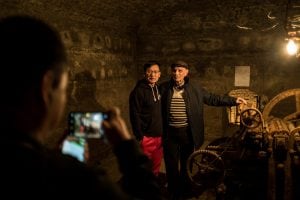 Chinese visitor taking a photo at the Joseph Stalin Underground