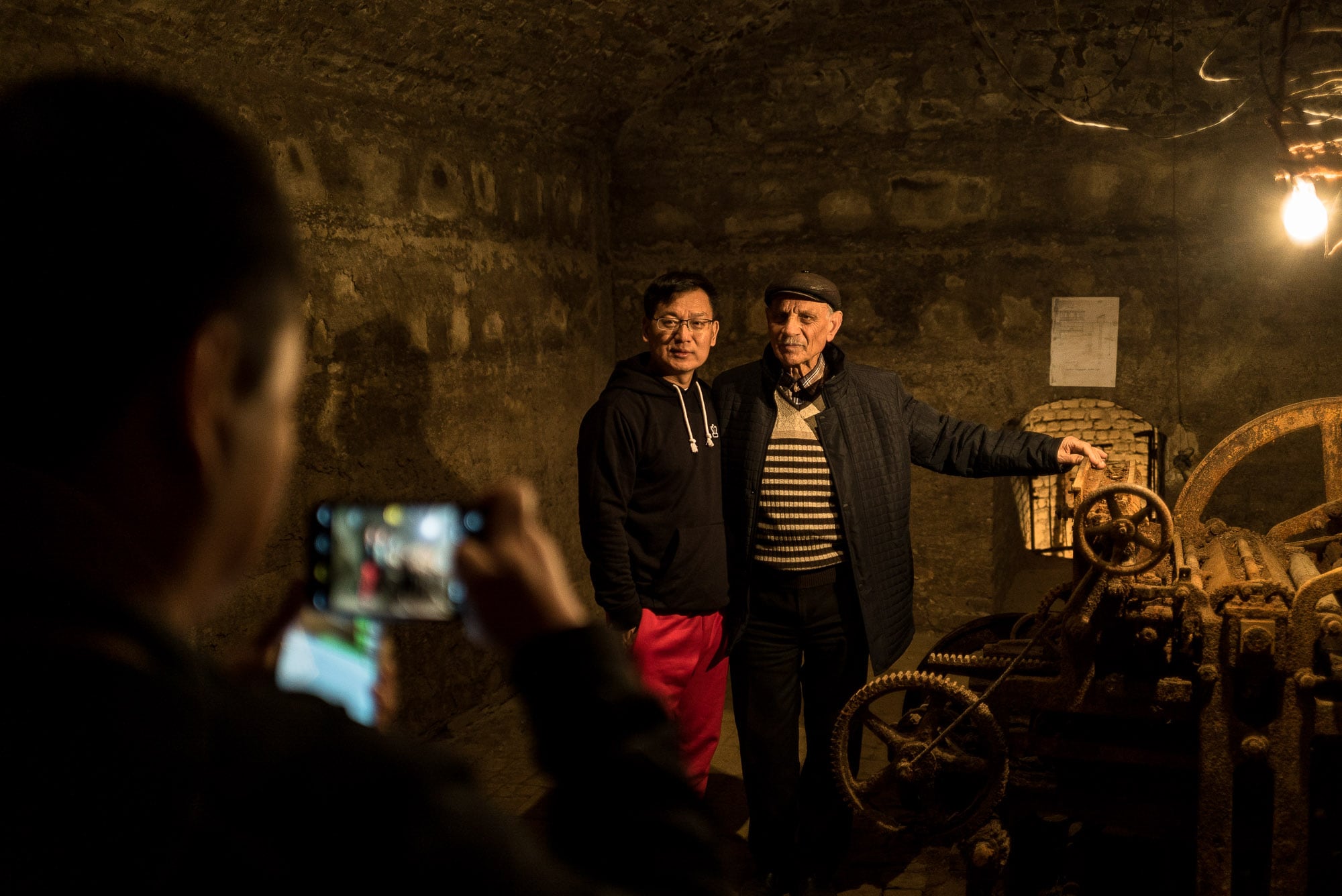 Chinese visitor taking a photo at the Joseph Stalin Underground