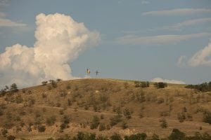 Romanian flag and a cross on a hill
