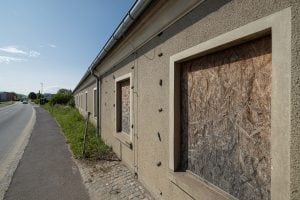 boarded-up windows of the former SS barracks